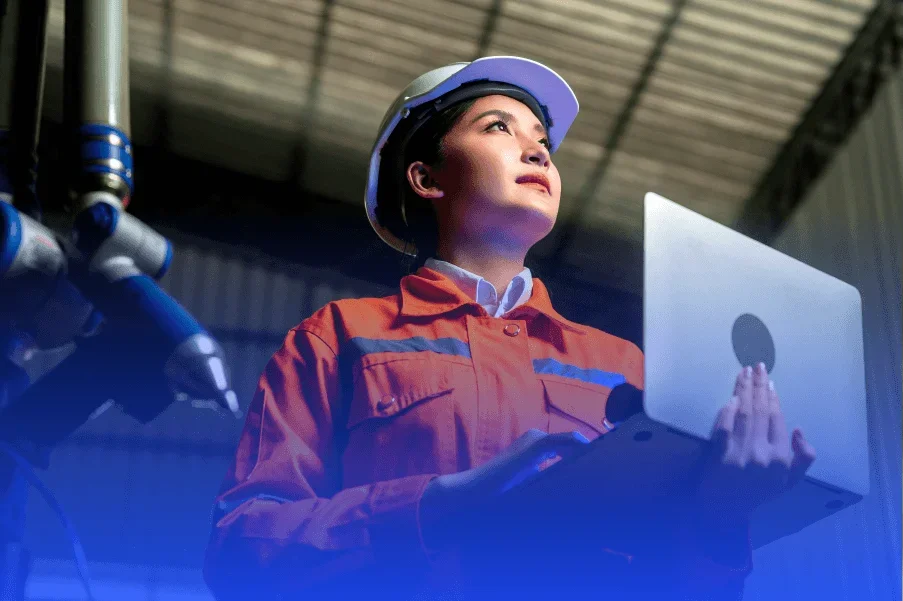 woman in hard hat holding laptop