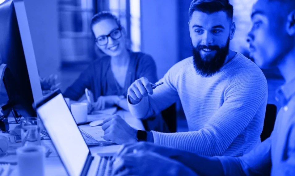 office workers looking at laptop