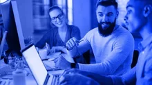 image of people looking at screen with a blue tint